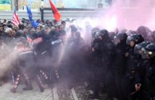 epa06397263 Albanian opposition supporters clashes with police in front of the parliament building in Tirana, Albania, 18 December 2017. Right-wing opposition MPs threw smoke bombs into the Albanian parliament hall to protest the Socialist majoritys election of a new prosecutor.  EPA/MALTON DIBRA