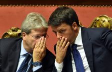 Italian Prime Minister Matteo Renzi (R) speaks with Foreign Affairs Minister Paolo Gentiloni after his speech focused on the next European Council, on October 14, 2015 at the Senate in Rome.  AFP PHOTO / ALBERTO PIZZOLI        (Photo credit should read ALBERTO PIZZOLI/AFP/Getty Images)
